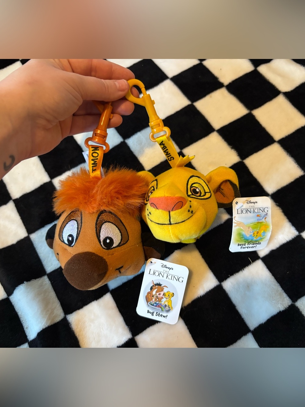 Lion king keychains one has a book one does not